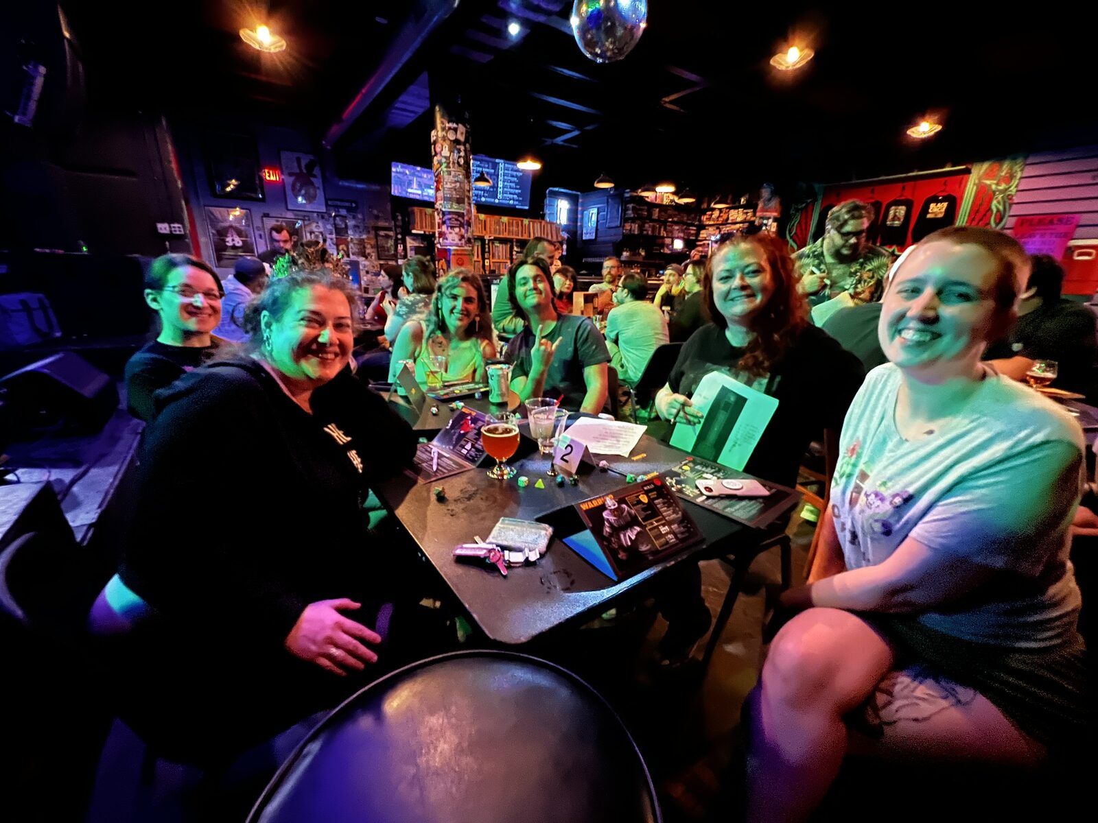 A packed game night in a dim bar