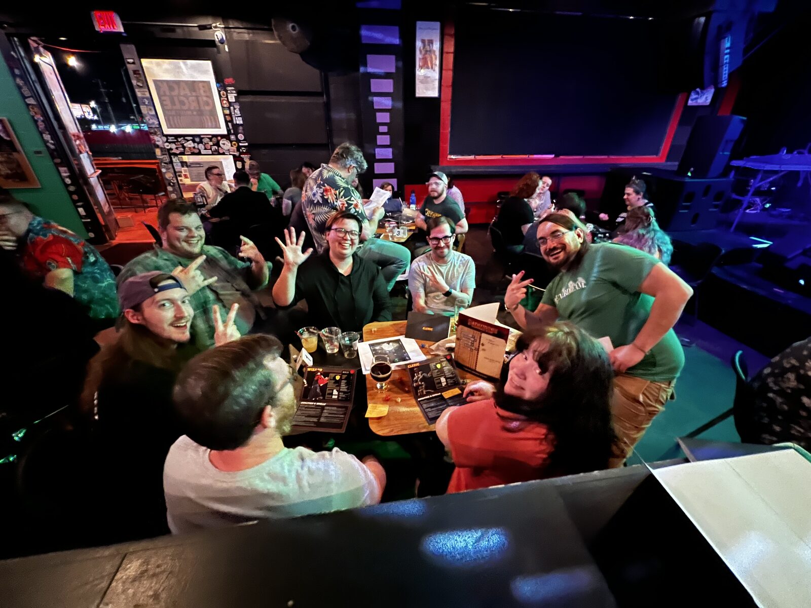 A packed game night in a dim bar